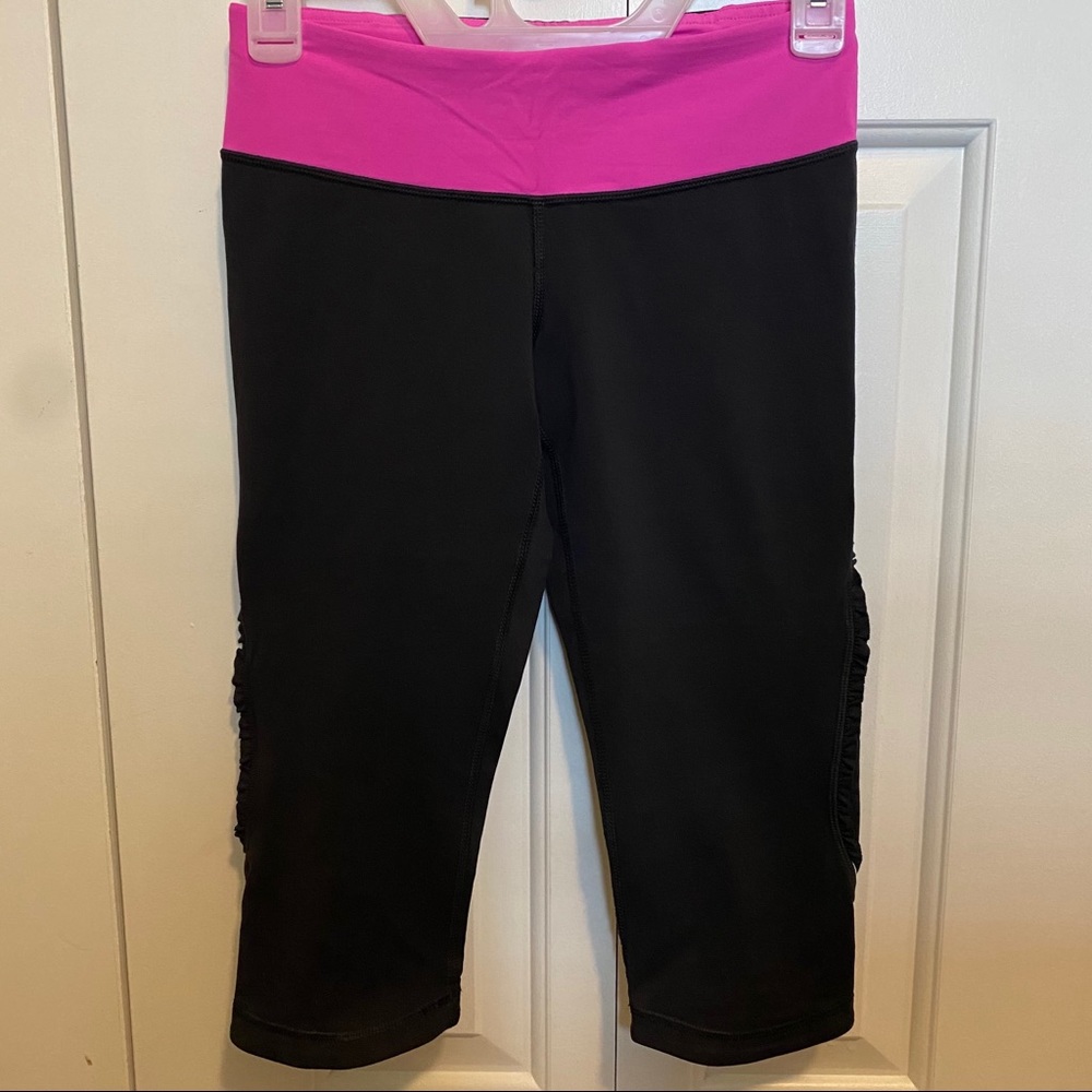 Lululemon black 3/4 length leggings; pink band; 4